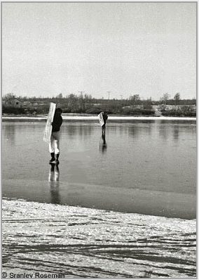 Carrying Roseman's newly painted canvases, Davis (foreground) and Anderson cross a frozen stretch of the Cbardasjohka River. Kautokeino, 1976. Photo  Stanley Roseman